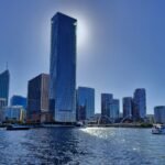 Stunning view of Perth skyline with sunlit skyscrapers reflecting on the Swan River.